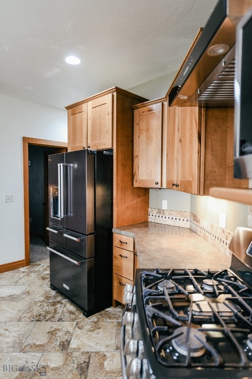 kitchen with stainless steel range with gas cooktop and high end black refrigerator