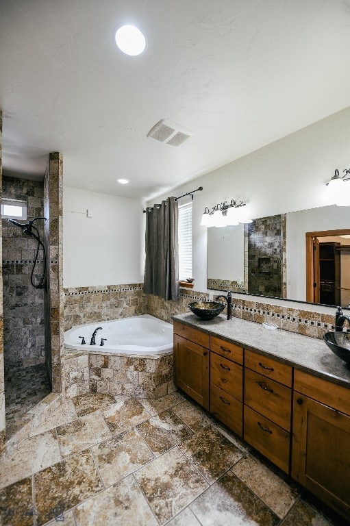 bathroom featuring vanity and separate shower and tub