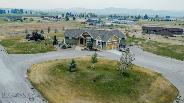 view of front of home with a mountain view and a garage