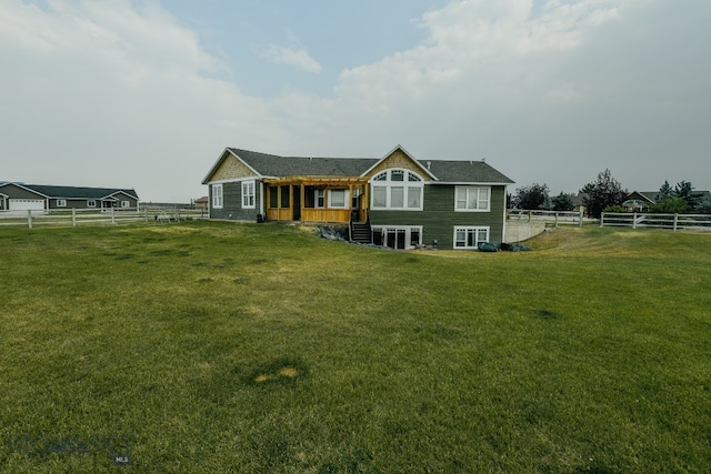 rear view of house with a yard