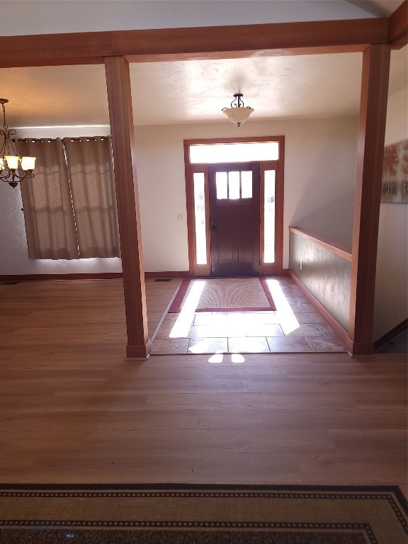 entrance foyer with a chandelier and hardwood / wood-style flooring