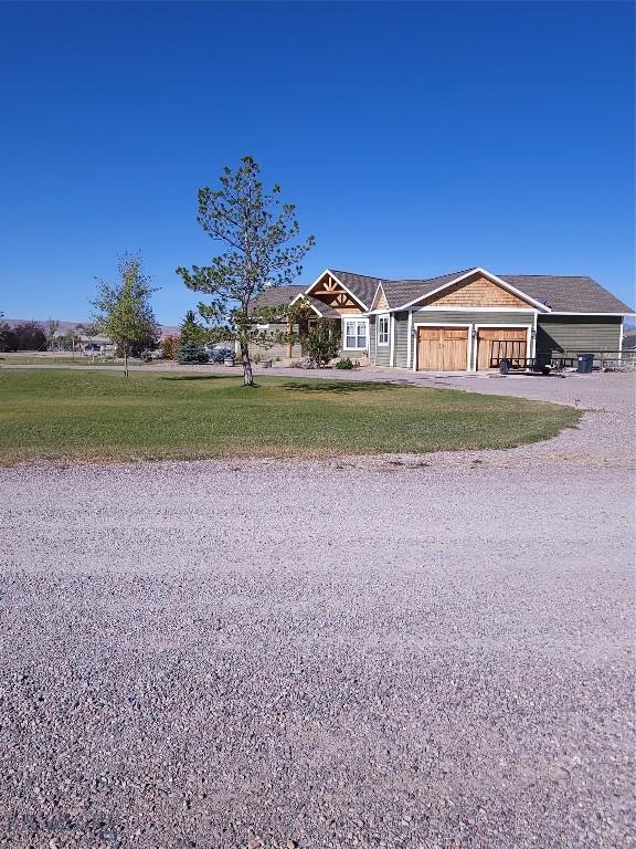 view of front facade with a front yard and an attached garage