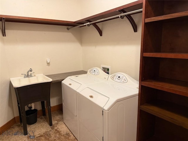 washroom featuring baseboards, laundry area, and independent washer and dryer