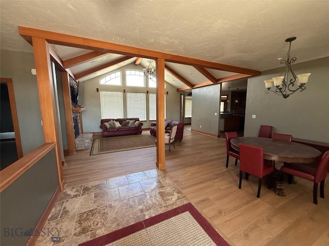dining area featuring baseboards, vaulted ceiling with beams, wood finished floors, and a notable chandelier