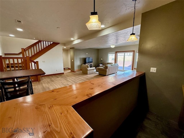 interior space featuring stairway, baseboards, wood finished floors, and recessed lighting