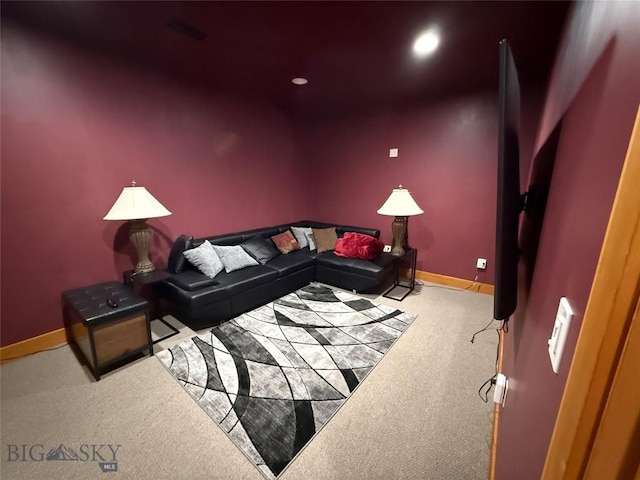 carpeted living area with baseboards and recessed lighting