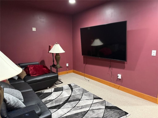 living area with baseboards and carpet