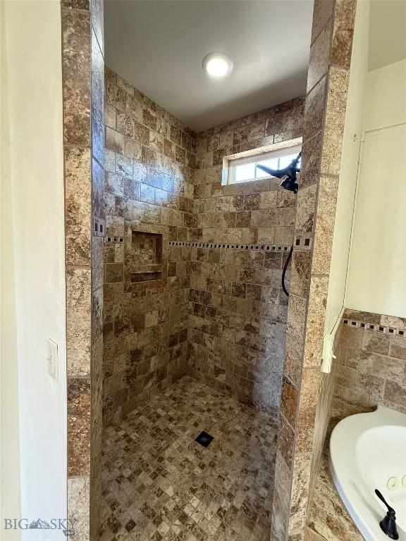 full bath with a garden tub and tiled shower