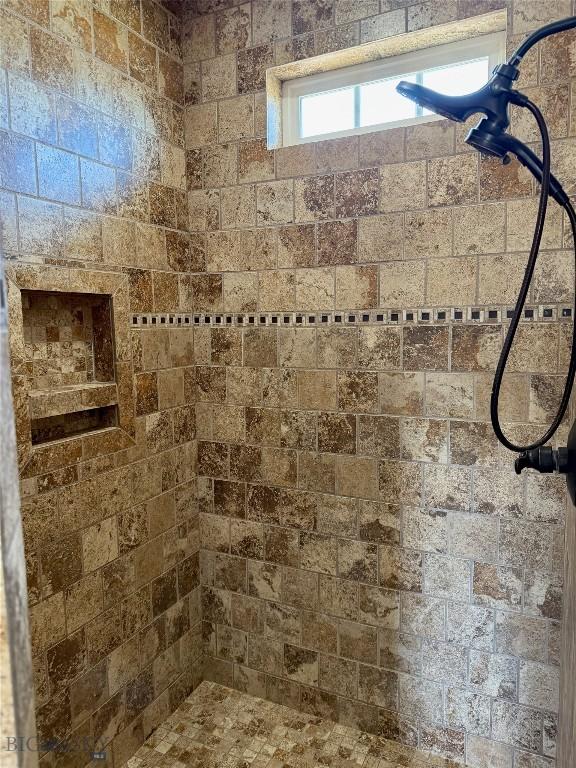 full bathroom with a tile shower