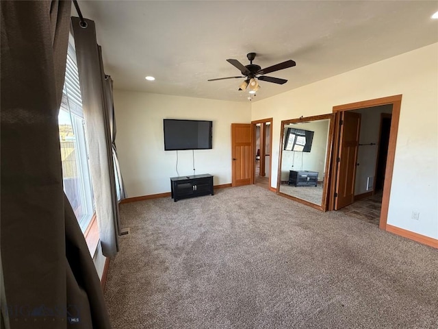 unfurnished living room featuring plenty of natural light, baseboards, and carpet flooring