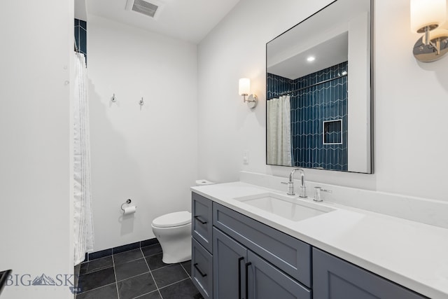 bathroom with tile patterned floors, toilet, and vanity