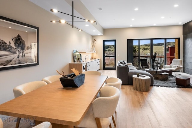 dining room with light wood finished floors and recessed lighting