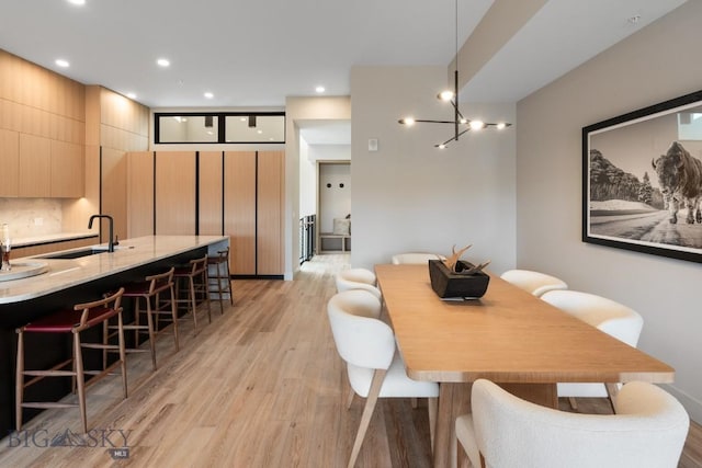 dining room featuring recessed lighting and light wood-style flooring