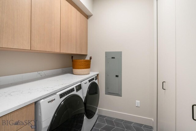 laundry room featuring dark tile patterned flooring, separate washer and dryer, baseboards, cabinet space, and electric panel