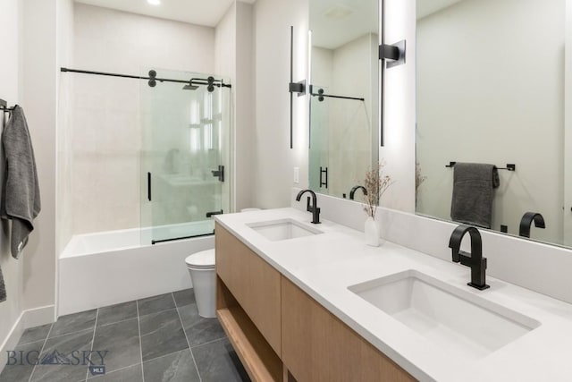 bathroom featuring enclosed tub / shower combo, a sink, toilet, and tile patterned floors