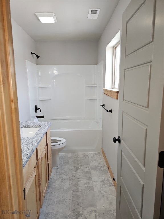 full bathroom with shower / tub combination, vanity, tile patterned flooring, and toilet