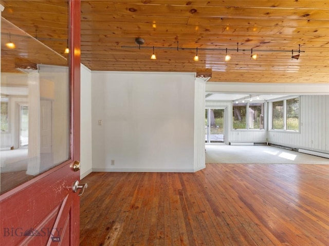 empty room with wood ceiling and hardwood / wood-style flooring