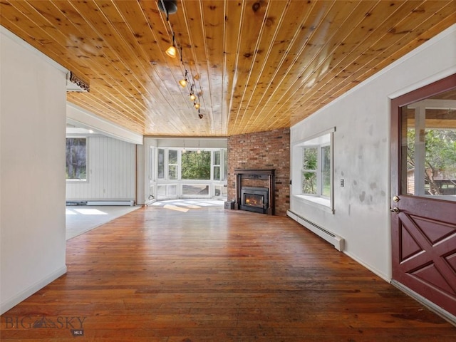 unfurnished living room featuring dark hardwood / wood-style flooring, a brick fireplace, wood ceiling, and baseboard heating