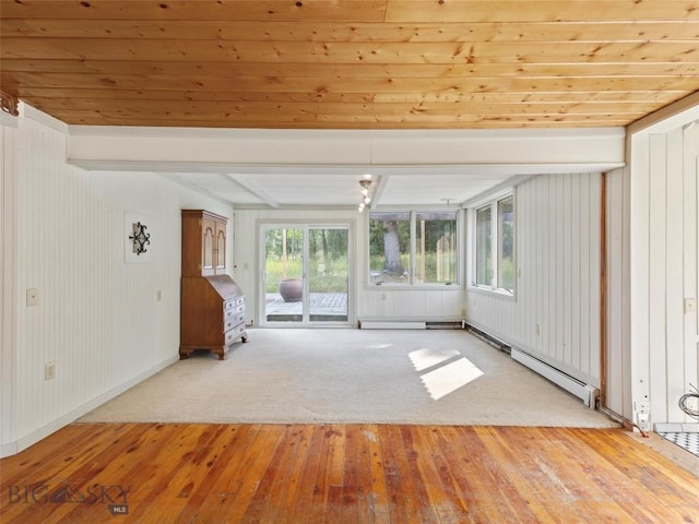 interior space with beamed ceiling, light hardwood / wood-style floors, and baseboard heating