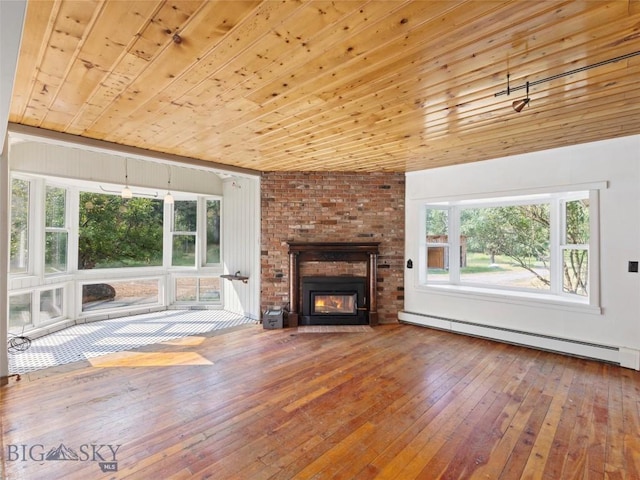 unfurnished living room featuring wood ceiling, vaulted ceiling, a fireplace, hardwood / wood-style floors, and a baseboard heating unit