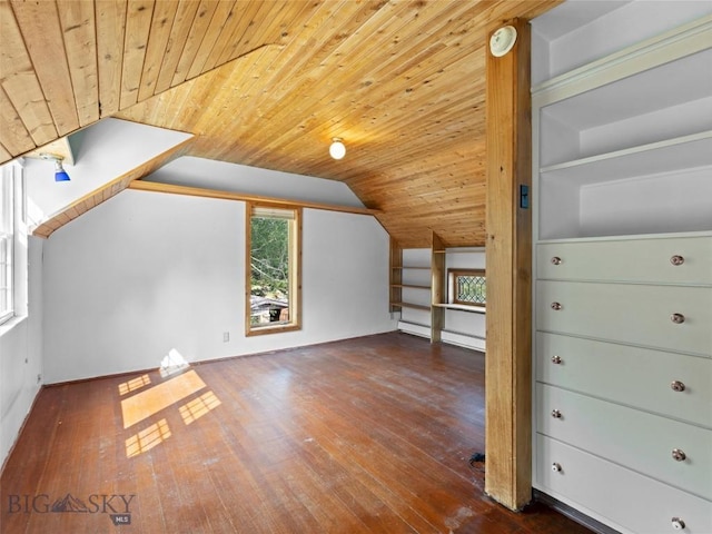 additional living space with built in shelves, vaulted ceiling, wooden ceiling, and dark hardwood / wood-style floors