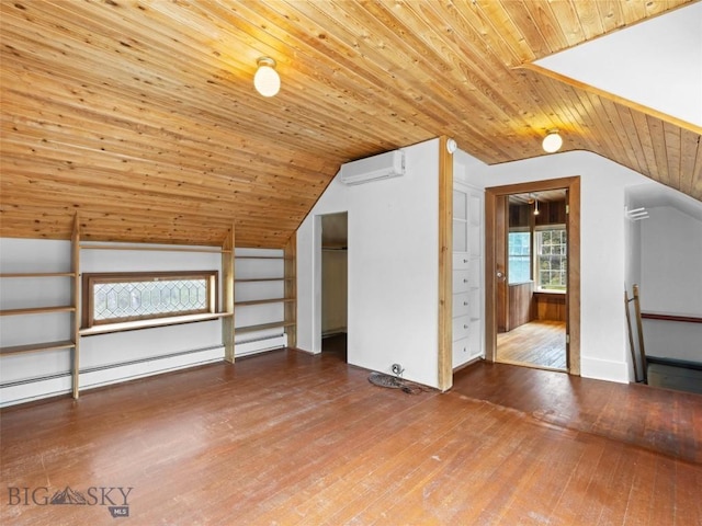 additional living space with wood-type flooring, wooden ceiling, an AC wall unit, and vaulted ceiling