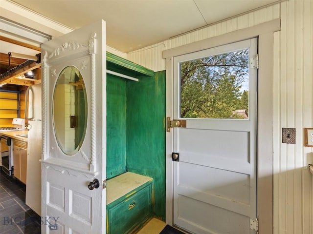 interior space featuring radiator heating unit, wooden walls, and dark tile patterned floors