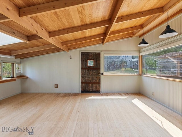 spare room featuring vaulted ceiling with beams, wood ceiling, and light wood-type flooring