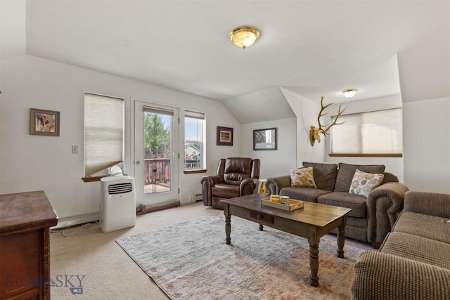 living room featuring light colored carpet and vaulted ceiling