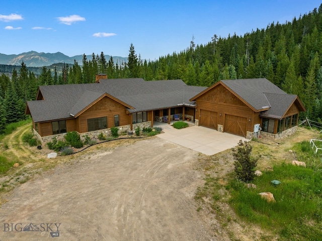 view of front of property with a mountain view and a garage