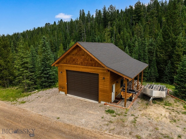 220 Watershed Rd, Big Sky, MT 59716 - detached garage with a forest view