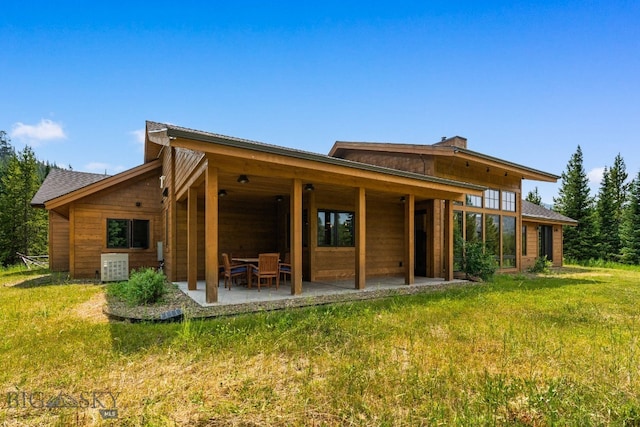 back of house featuring a yard, a patio, and central AC unit