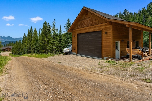 220 Watershed Rd, Big Sky, MT 59716 - detached garage featuring a mountain view and dirt driveway