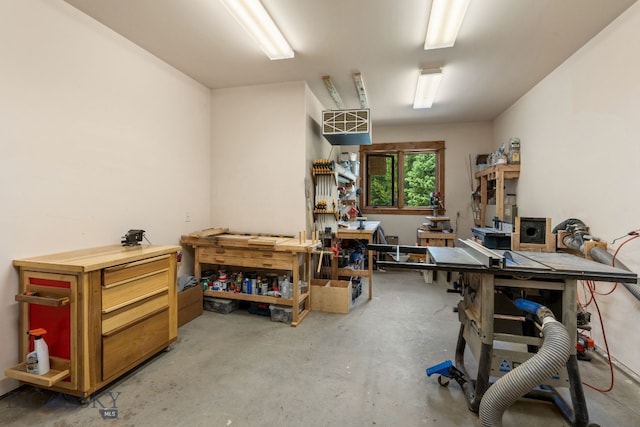 misc room with a workshop area and concrete floors