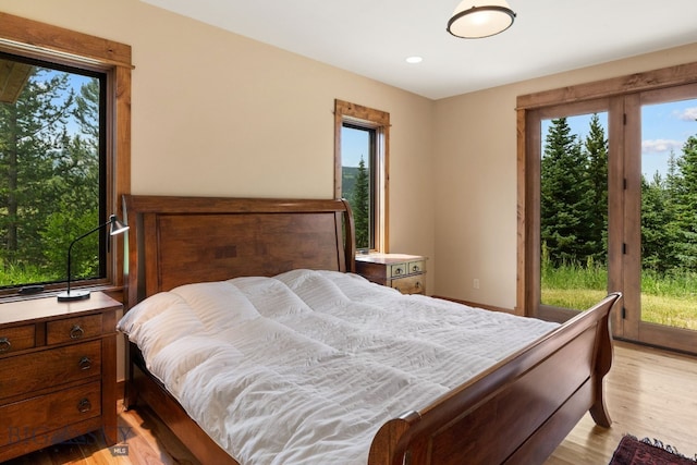 bedroom featuring light wood-type flooring and multiple windows