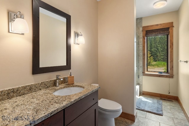 220 Watershed Rd, Big Sky, MT 59716 - bathroom featuring toilet, vanity, a shower, baseboards, and tile patterned flooring