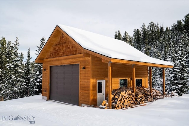 220 Watershed Rd, Big Sky, MT 59716 - snow covered garage with a detached garage