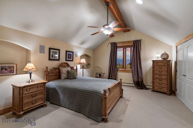 carpeted bedroom featuring ceiling fan, vaulted ceiling with beams, a closet, and a baseboard heating unit