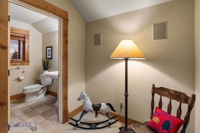 bedroom featuring light tile patterned flooring and vaulted ceiling