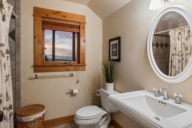 bathroom with tile patterned flooring, lofted ceiling, a shower with shower curtain, toilet, and sink