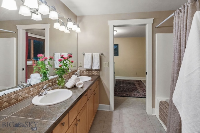 bathroom with vanity, shower / bath combo with shower curtain, and tile patterned flooring