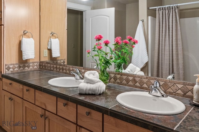 bathroom with decorative backsplash and vanity