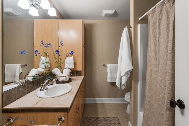 bathroom featuring a shower with curtain, vanity, tile patterned flooring, and toilet