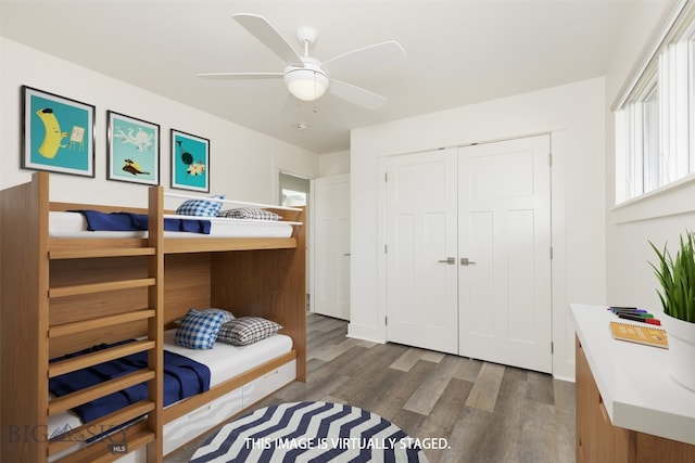 bedroom with ceiling fan, a closet, and wood-type flooring