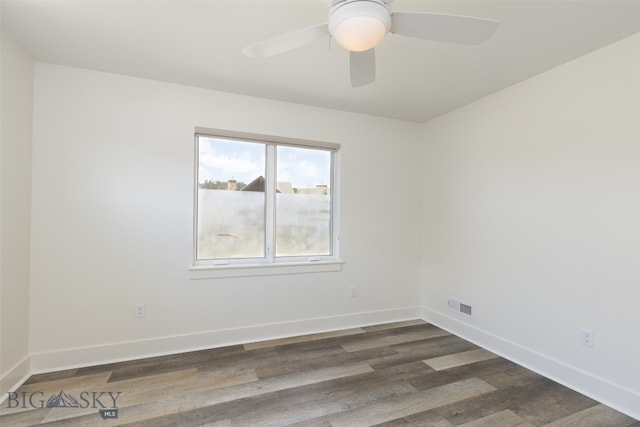 spare room featuring dark hardwood / wood-style floors and ceiling fan