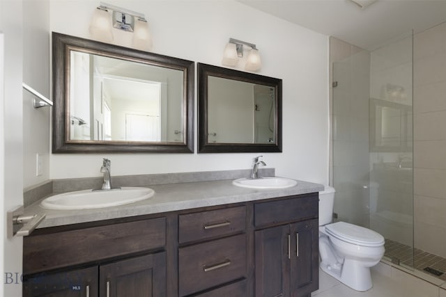 bathroom with tile patterned floors, toilet, an enclosed shower, and dual bowl vanity