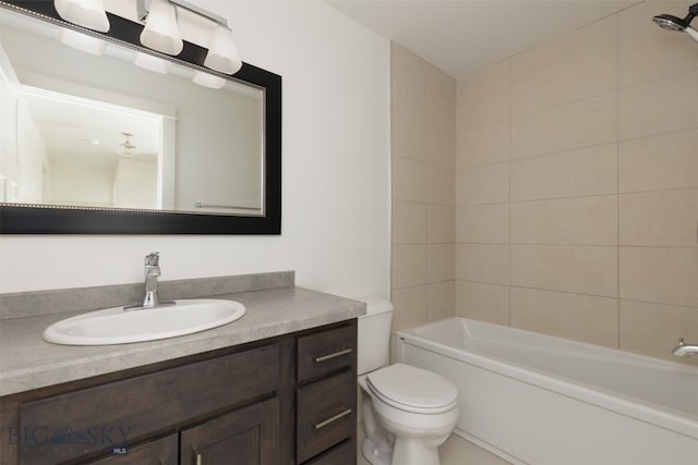 full bathroom with tiled shower / bath combo, toilet, and vanity