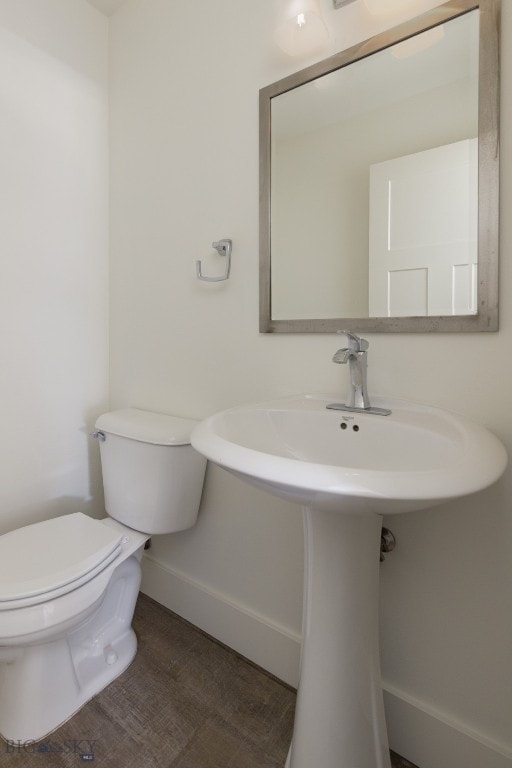 bathroom featuring sink, hardwood / wood-style flooring, and toilet