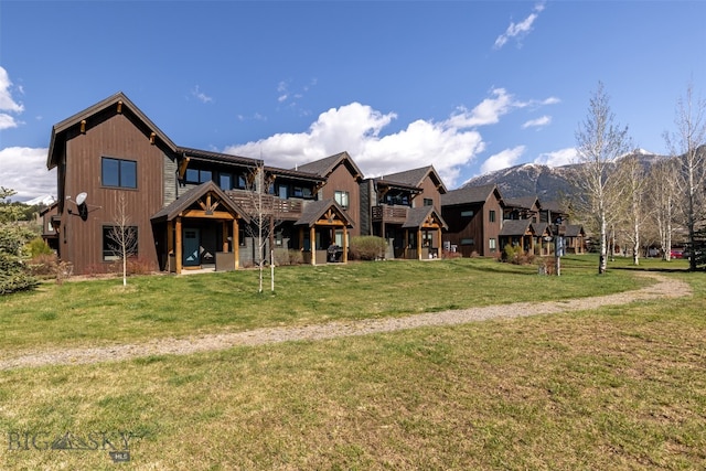 exterior space with a yard and a mountain view