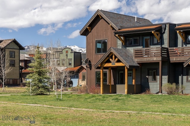 view of front facade featuring a balcony and a front yard